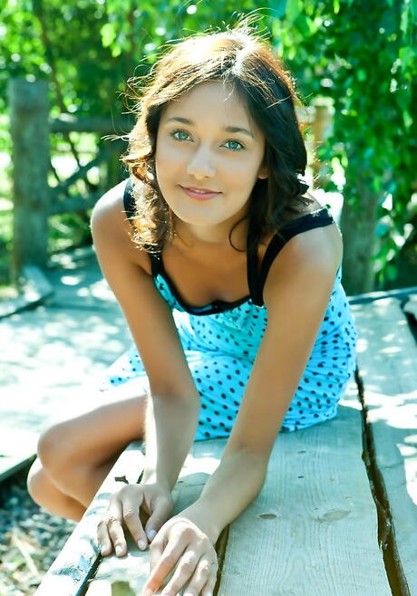 Sylphlike dark-haired youthful Chandra A in sexy skirt in foot fetish show outside