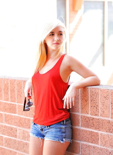 Stunning blond young Jayde exposing big tits and bald pussy outdoor